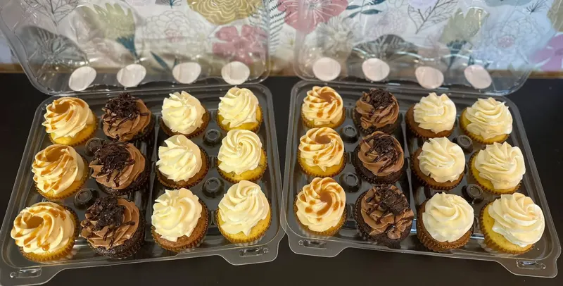 Trays of Boujie Baker cupcakes