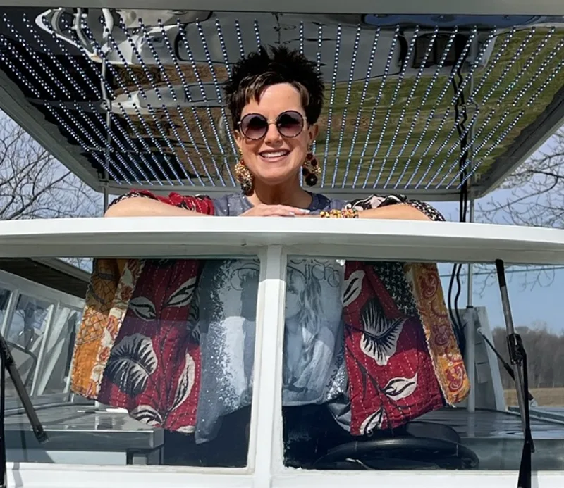 Kate Studt smiling from the pop-top window of the Boujie Baker van
