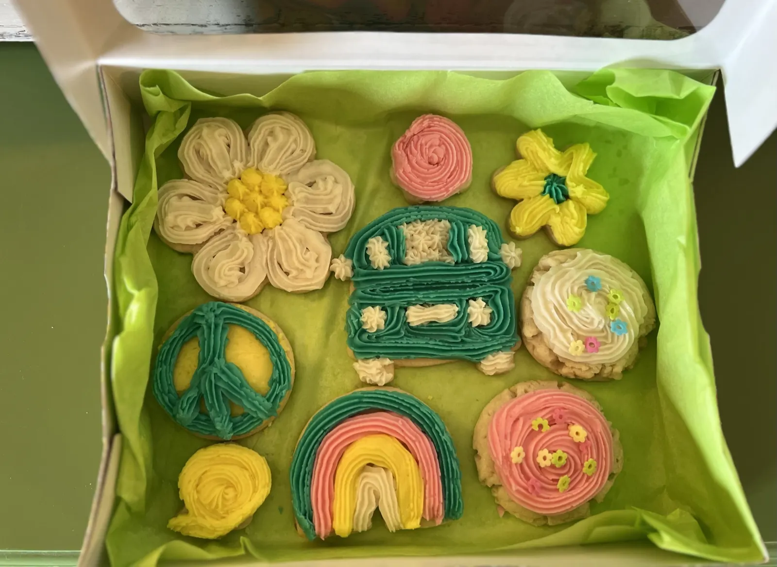 Sugar cookies shaped like a VW van, peace sign, rainbow and flowers